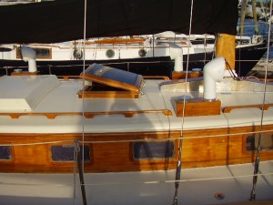 Five coats.  The masts are up.   Hatch hardware installed.  It’s time to put the gear back aboard and clean up the cabin.  It’s a mess.