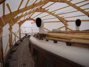 A view from the deck (looking forward) just before starting the work of pulling up the old teak.  Foam or bubble-wrap should be taped at all corners to protect the tarp from tears. 