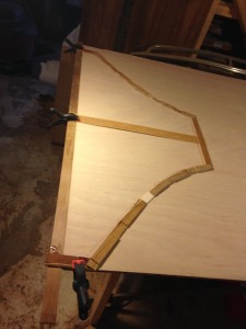 The completed pattern is transferred to the plywood by tracing its perimeter.