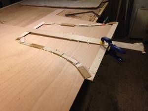 Using the pattern, the shape is transferred to marine plywood.